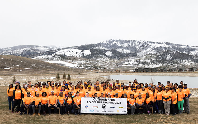 Group photo of the Outdoor Afro leadership training members posing in front of mountains. Visit https://outdoorafro.org/